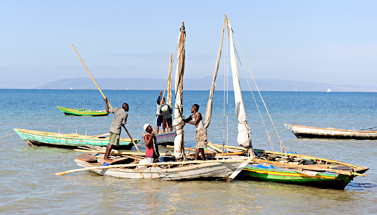 Saintard, Haiti - March 2, 2016:  Five unidentified Haitian fishermen preparing their boats for a day's work.