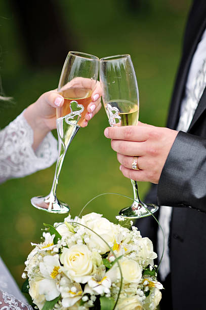 istock Bride and groom are holding champagne glasses 519343792