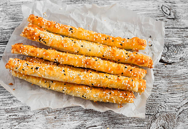 istock Homemade cheese bread sticks on a light wooden background 519344398