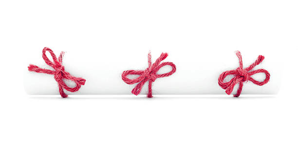 istock White letter tube tied with rope, three red bows isolated 519344576