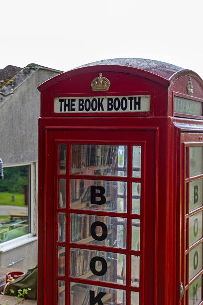 The book booth Noss mayo, Devon, UK, July 29 2015 - Showing a BT / GPO phone booth converted to a book share on a camp site situated in the south hams, The book share allows sawpping and borrowing of books free of charge, and is made availible by BT selling of the phone box british telecom photos stock pictures, royalty-free photos & images