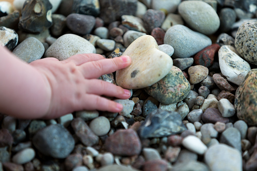 Baby hand on stones