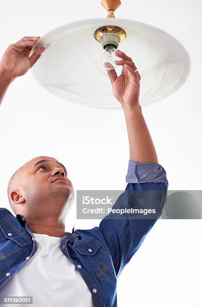 Fixing A Lightbulb Stock Photo - Download Image Now - Change, Light Bulb, Energy Efficient Lightbulb