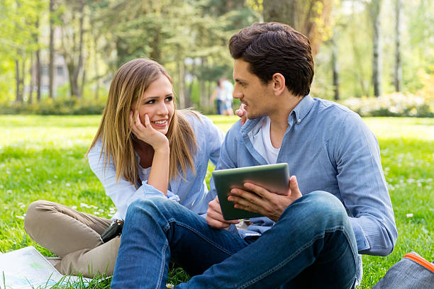 istock Young couple with tablet computer in the park 519360350