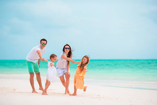 istock Happy young family on beach vacation 519360562