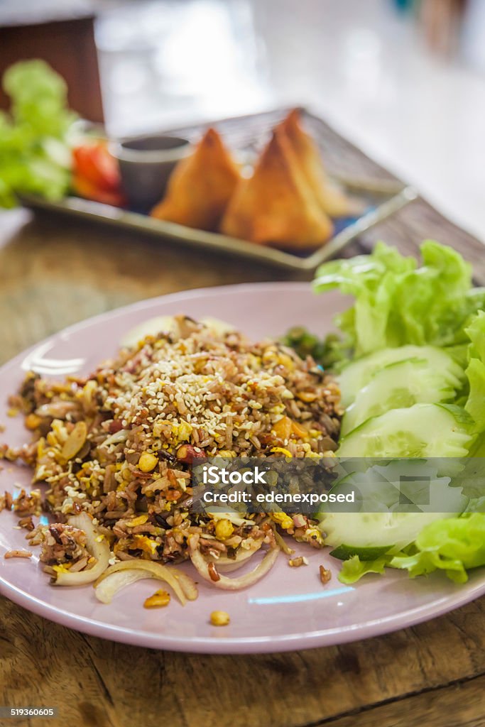 Thai Style Fried Rice with Salad A plate of Thai style fried rice served with salad. Fried Rice Stock Photo