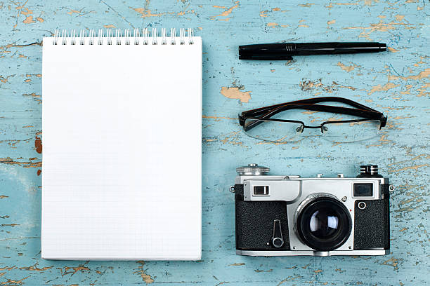 istock Tourism, travel concept. Office desk table with notepad, camera and 519360772