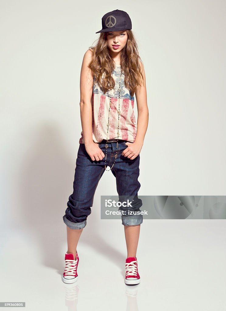 Rock style Woman, Studio Portrait Portrait of contemporary young woman wearing rock style clothes, looking at the camera. Studio shot, white background. 20-24 Years Stock Photo