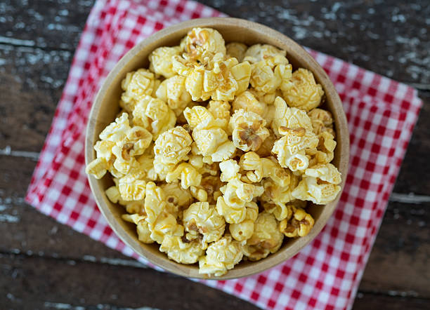 istock popcorn in brown bowl on dark wooden table. 519360830