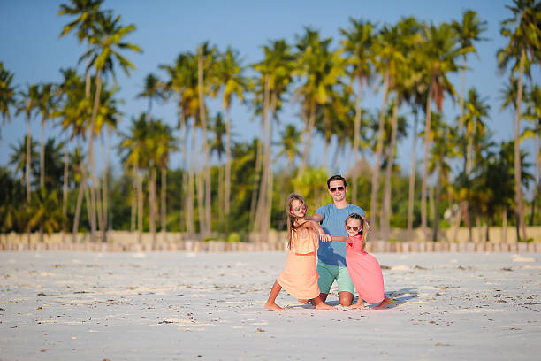 istock Young family enjoying beach summer vacation 519360974