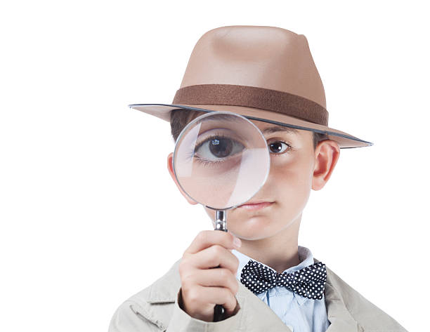 istock Little detective looking through magnifying glass with clipping path 519361299