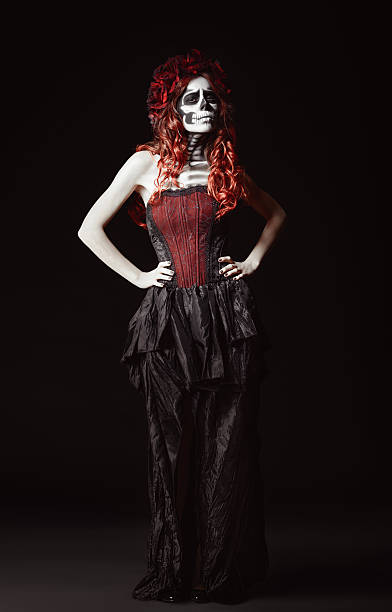 istock Sad young woman with muertos makeup (sugar skull). Full length 519361665