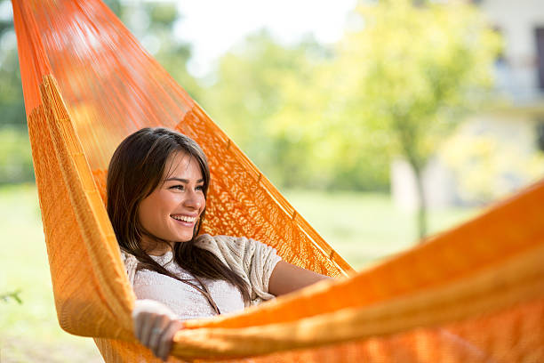 istock Smiling girl resting in hammock 519361934