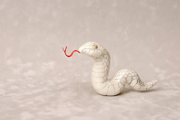Snake made from clay on abstract background Snake made from clay on abstract background. snake with its tongue out stock pictures, royalty-free photos & images