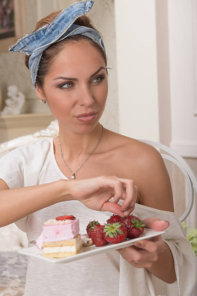 istock Girl eats a berry dessert 519362873
