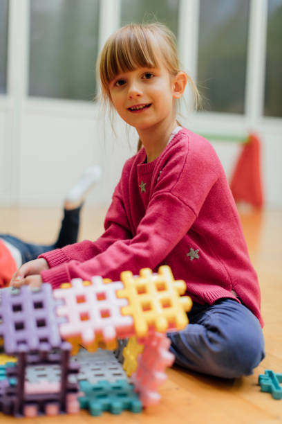 istock Cute girl playing with blocks in kindergarten 519363044