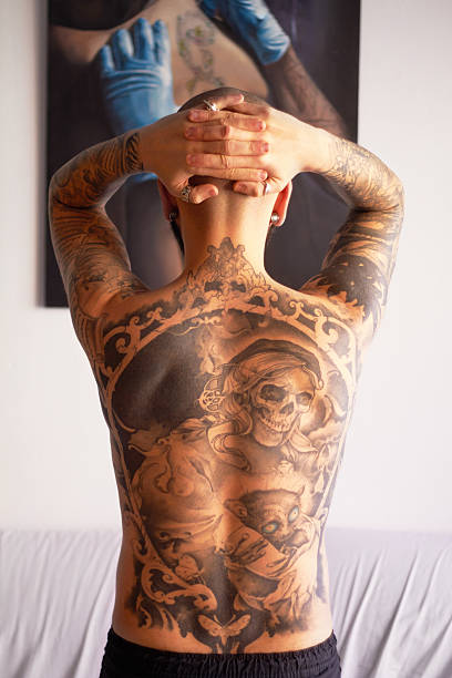 My body of work Rearview shot of a young man with tattoos on his back chest tattoos for men designs stock pictures, royalty-free photos & images