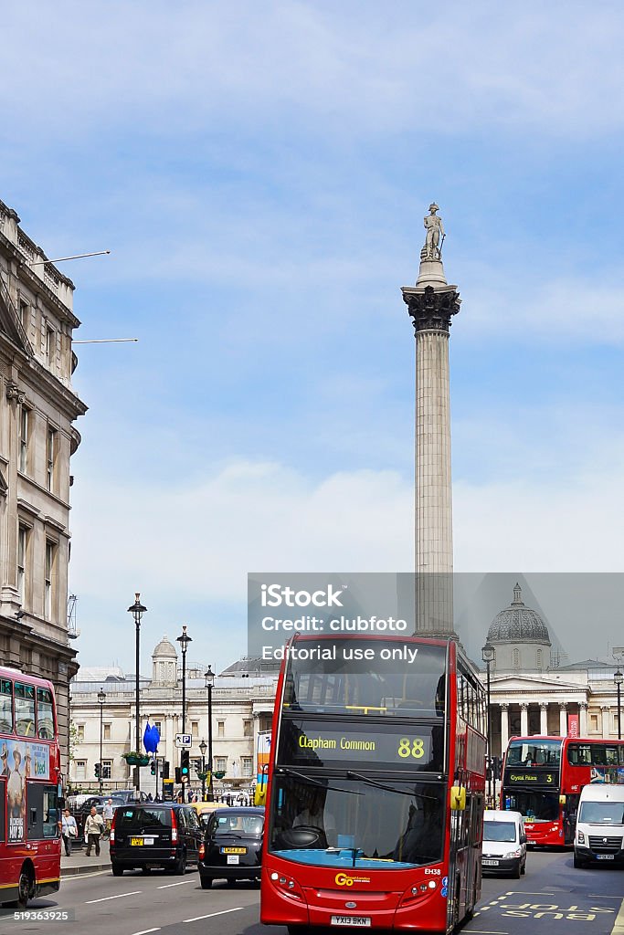 London bus and Trafalgar Square, London, UK London, United Kingdom - May 21, 2014: London streets around Trafalgar Square are full of traditional Black taxi cabs and red double decker buses,  this image also shows Nelsons Column and in the distance the blue artwork known as Hahn/Cock. Black Color Stock Photo