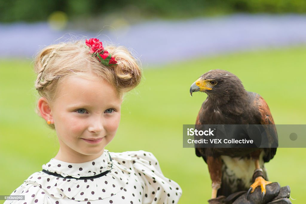 Cheecky girl with owl A blonde 2 year old girl with parasol; dressed in edwardian outfitA blonde 6 year old girl with parasol; dressed in edwardian outfitA 6 year old girl, dressed in edwardian style is posing with  a beautiful owl 2-3 Years Stock Photo