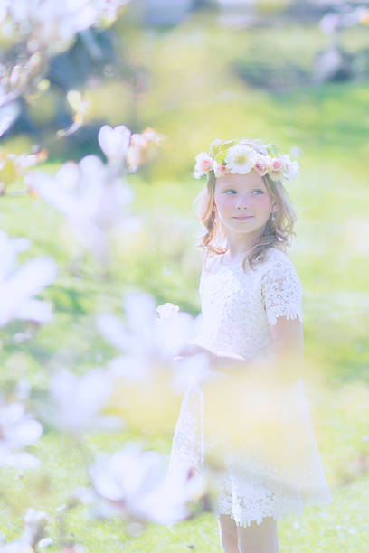 istock Blonde Girl and a magnolia tree 519364608