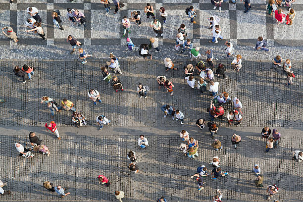 Prague, Czech Republic - September 9, 2014: Large group of tourists at Prague central square looking up to Old Town Hall tower.