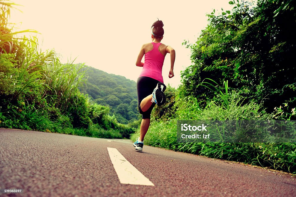 Runner athlete running on forest trail. Runner athlete running on forest  trail. woman fitness jogging workout wellness concept. Active Lifestyle Stock Photo