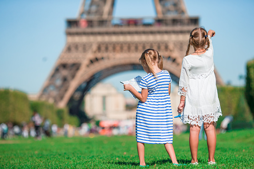 Adorable little girls in Paris background the Eiffel tower in France