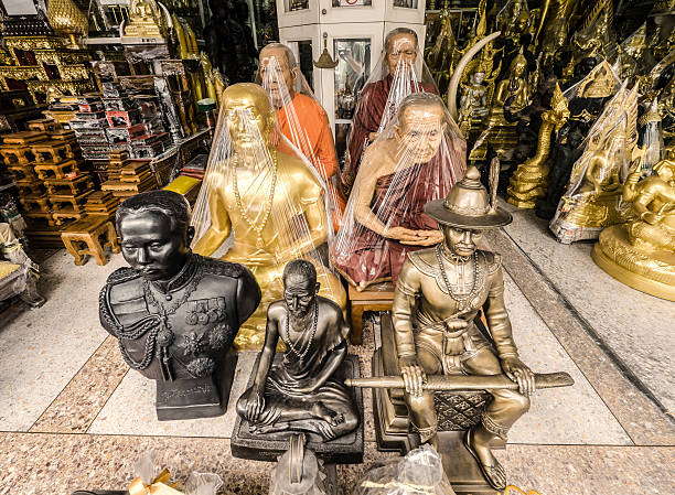 Bangkok, Thailand - February 16, 2016: A souvenir religious shop around the Wat Suthat temple in Bangkok Thailand. Many of these shops have very realistic sculptures of buddhist monks like the ones seen in this picture 