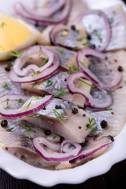 istock Sliced herring with pepper, herbs, salt, onion 519367108
