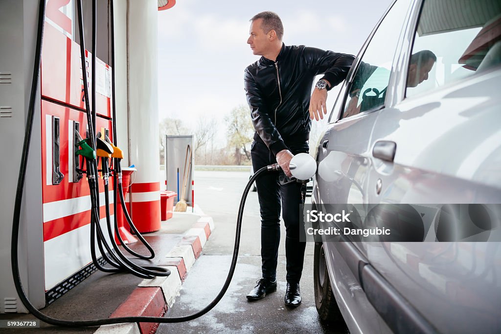 At Gas Station Man At Gas Station Filling Up Her Car With Petrol Refueling Stock Photo