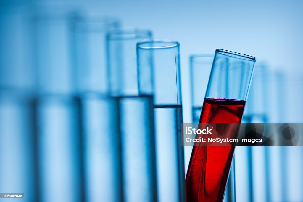 Blood Test tubes filled with blue and red liquid. Standing out of crowd concept. Scientific research concept Blood Stock Photo