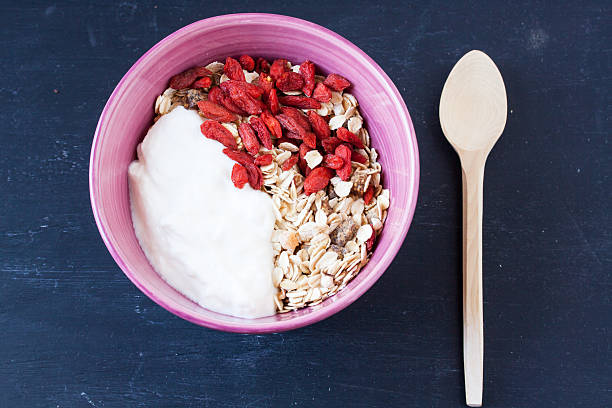 muesli with yogurt and goji berry on a black background