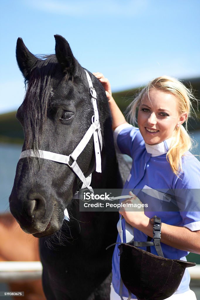 He loves it when I rub his head Shot of a beautiful young woman standing next to her horse 20-29 Years Stock Photo