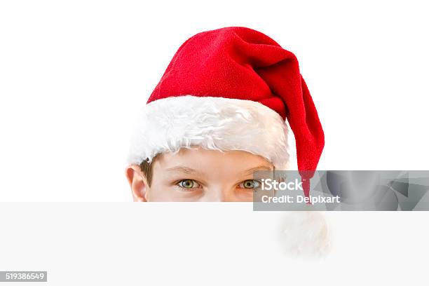 Boy In Red Santa Hat Hiding Behind A Blank Paper Stock Photo - Download Image Now - Advertisement, Banner - Sign, Behind