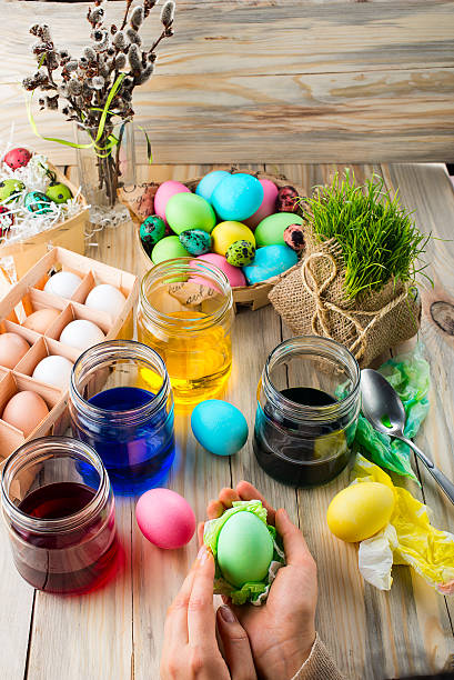 istock Coloring eggs in bright colors for Easter holiday 519386854