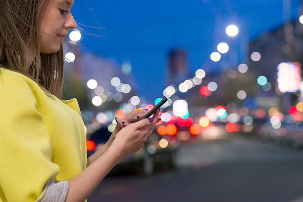 istock Woman hand using a smart phone in the night 519386916