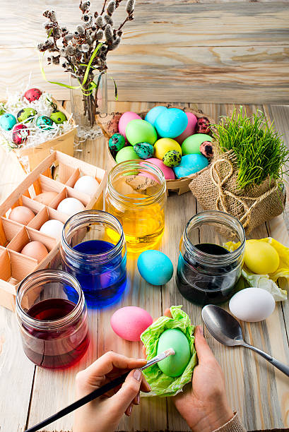 istock Female hands coloring eggs for Easter holiday 519387504