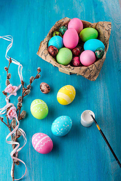 istock Painting Easter eggs in bright colors on wooden table 519387996