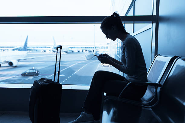 istock Woman using internet in the airport 519388342