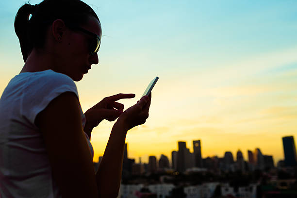 istock Woman using phone in the city 519388582