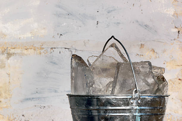 istock Bucket of ice on dirty wall background 519389200