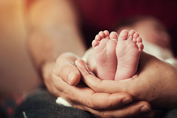 istock Baby feet in the parents hands 519389906