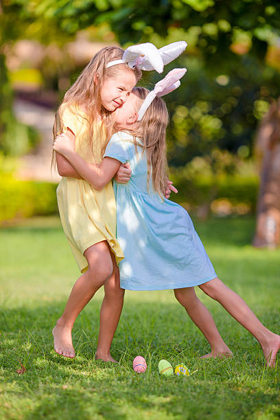 istock Two adorable little sisters wearing bunny ears on Easter day 519390728