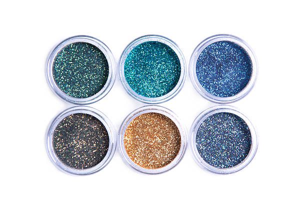 Bright cosmetic glitters in transparent jars stock photo