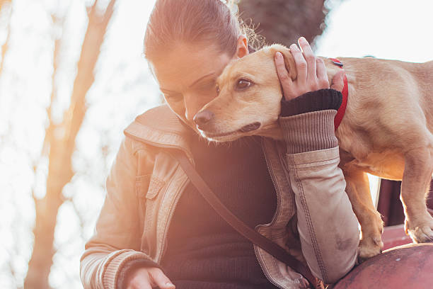 istock Woman gently hugging her pet dog 519392324