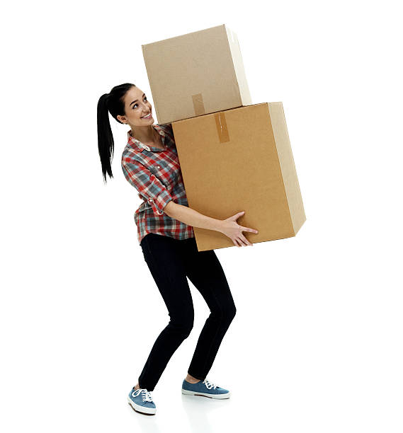 istock Smiling female carrying box 519392382