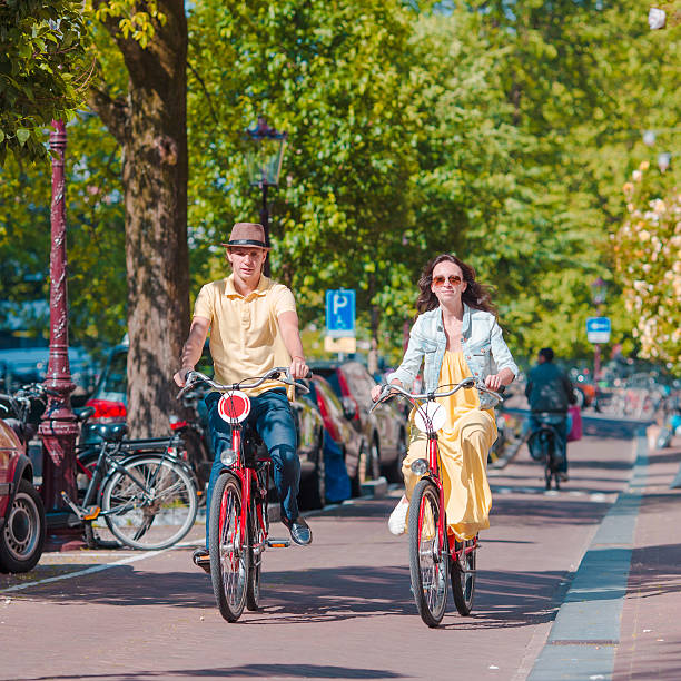 istock Young happy caucasian couple on bikes in Amsterdam 519393492