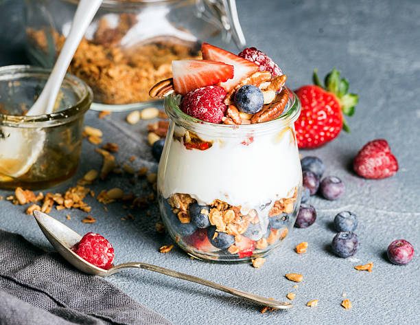 istock Yogurt oat granola with fresh berries, nuts, honey and mint 519394848