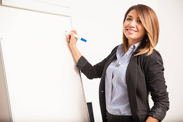 istock Pretty businesswoman writing on a board 519395912