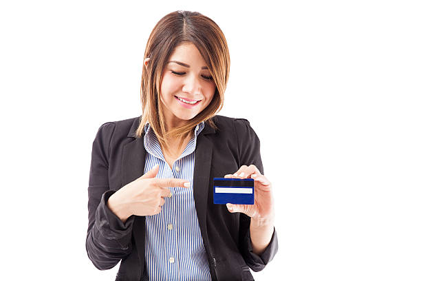 istock Pretty brunette pointing at a credit card 519396370